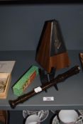 A 1970s laminated wood metronome, measuring 25cm high, a Yamaha recorder, and a boxed Harmonica