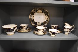 A Royal Crown Derby cobalt and gilt decorated part teaset, comprising four cups, four saucers,