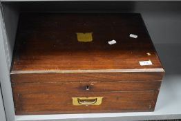 A 20th century oak cased part canteen of silver-plated cutlery, the lift-up top with central brass