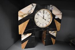 An Art Deco inspired stone sample mantel clock, the canted rectangular top raised on two