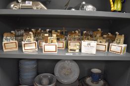 A collection of twenty four Van Hill Pottery 'Mud Larks' model English Country buildings, each