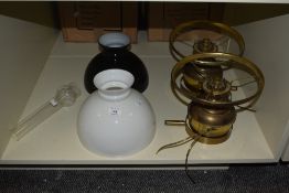 Two Victorian brass oil lamps with black and white shades, each measuring 40cm high