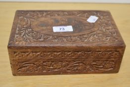 A 20th Century Indian carved wooden jewellery box with wire inlay to the vacant oval cartouche on