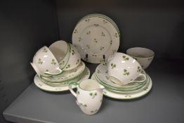 A Shelley (Late Foley) shamrock decorated part teaset, comprising four cups, six saucers, five