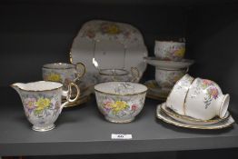 A selection of Melba porcelain tea ware, hand painted with a foliate pattern and heightened with