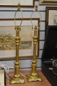 A pair of reproduction Victorian gilt metal and resin table lamps, each measuring 70cm high
