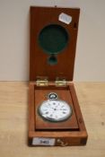 A large white metal open face pocket watch, having a white dial with Roman numerals, within a fitted
