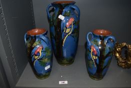 A group of three decorative Longpark pottery Torquay ware vases, one large and a pair of smaller,