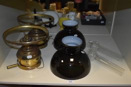 A pair of 19th Century brass mounted light fittings, converted from oil lamps with black glass light
