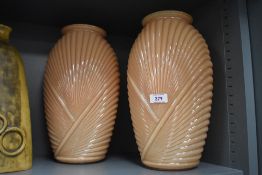 A pair of late 20th Century peach, ribbed glass vases in the Art Deco style, each measuring 33cm