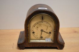 An early 20th century oak cased and arched chiming mantel clock, with Arabic hours