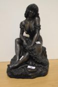 A 20th Century cast resin sculpture of a seated lady, signed 'John Letts' to the reverse,