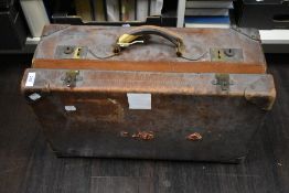 An early 20th Century brown stitched leather suitcase, measuring 23cm x 36cm x 57cm