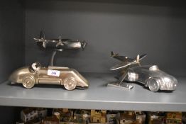 A group of vintage transport related desk ornaments, two vintage roadsters and two aeroplanes in