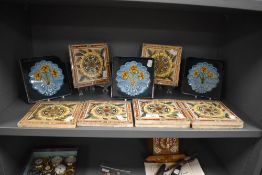 A collection of eight Victorian pottery tiles, decorated with stylised sunflower design, marked E,