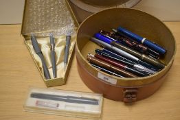 A vintage leather collar box containing approximately 23 fountain pens and an AF pen set in grey