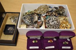 A collection of costume jewellery, including brooches of various design, paste set examples, belt