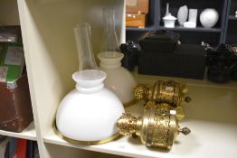 A pair of late 19th Century Gothic wall mounted brass oil lamp fittings, having banded quatrefoil