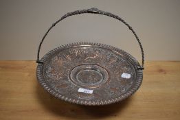 A silver plated fruit basket, of circular form with swing over-handle and short flared circular
