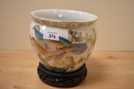 A 20th Century Chinese porcelain jardiniere, decorated in polychrome with exotic birds on