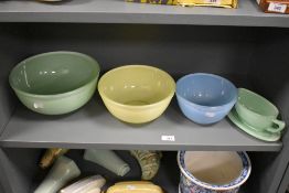 Three mid century graduating Pyrex bowls, green, yellow and blue, together with a green Pyrex