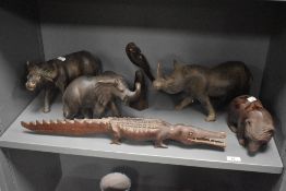 A collection of six carved wooden animals, mainly African, elephant, rhino, crocodile but