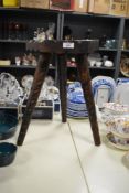 A carved and stained pine hexagonal stool.