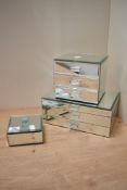 Three modern mirrored dressing table top jewellery boxes, a square box, a three drawer chest and a