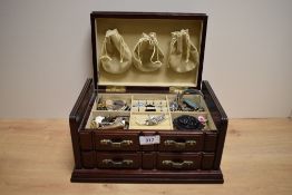 A wooden jewellery box, having cream lining, containing a collection of costume jewellery