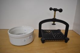 A 20th Century cast iron meat press with bowl, measuring 26cm high