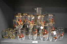 A vintage gilt and hunting scene decorated lemonade set and other glasses, to include three Highland