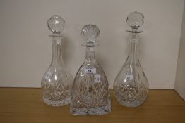 A 20th Century lead crystal glass decanter and stopper of triangular form, measuring 27cm high,