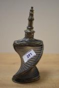 A mid-20th Century engraved white metal and glass scent bottle, of twisted form and measuring 20cm