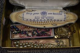 An assortment of costume jewellery, including faux pearls, beaded necklaces and bangles etc