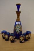 An early 20th Century Bohemian cobalt blue glass decanter, hand painted and heightened with gilding,