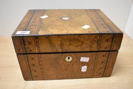 A large wooden box, having decorative wooden and mother-of-pearl inlays, containing an assortment of