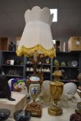 A 19th Century French porcelain table lamp, decorated with hand painted figural vignettes with