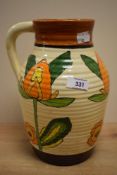 An unusual 1930's Clarice Cliff style Bizarre Lotus jug, moulded with ribs and hand decorated with