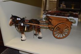 A vintage porcelain shire horse and cart ornament, measuring 65cm long overall