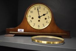 A mid century walnut arched mantel clock, with Arabic hours, marked Kieniger 21cm