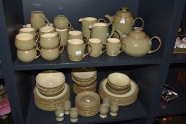 A large selection of Denby stoneware table ware, in the Camelot design, including tea and coffee