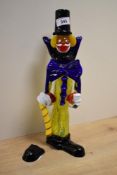 A vintage Murano glass clown figure, of typical form with oversized bow tie and holding a cane,