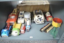 A shelf of Tonka Toys including Tow Trucks, three wheel bike etc along with a BigTrak Toy etc