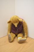 A mid 20th century straw filled yellow plush Teddy Bear having plastic eyes, stitched nose, original