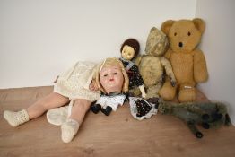 A mid 20th century straw filled yellow plush Teddy Bear having plastic eyes, stitched nose and