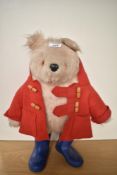 A Gabrielle Designs Paddington Bear having plastic eyes and nose, wearing red jacket and blue