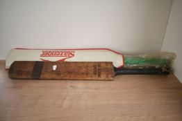 A vintage Cricket Bat, Hurricane Driver Treble Spring along with a later Duncan Fearnley Cricket Ba