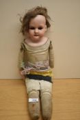 A Victorian Armand Marseille bisque headed doll having sleep blue eyes, painted eyebrows, open mouth