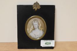 19th Century School, a portrait miniature of a woman with white headdress, set within an ebonised