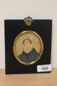 19th Century School, a portrait miniature of a lady wearing a bonnet, set within an ebonised